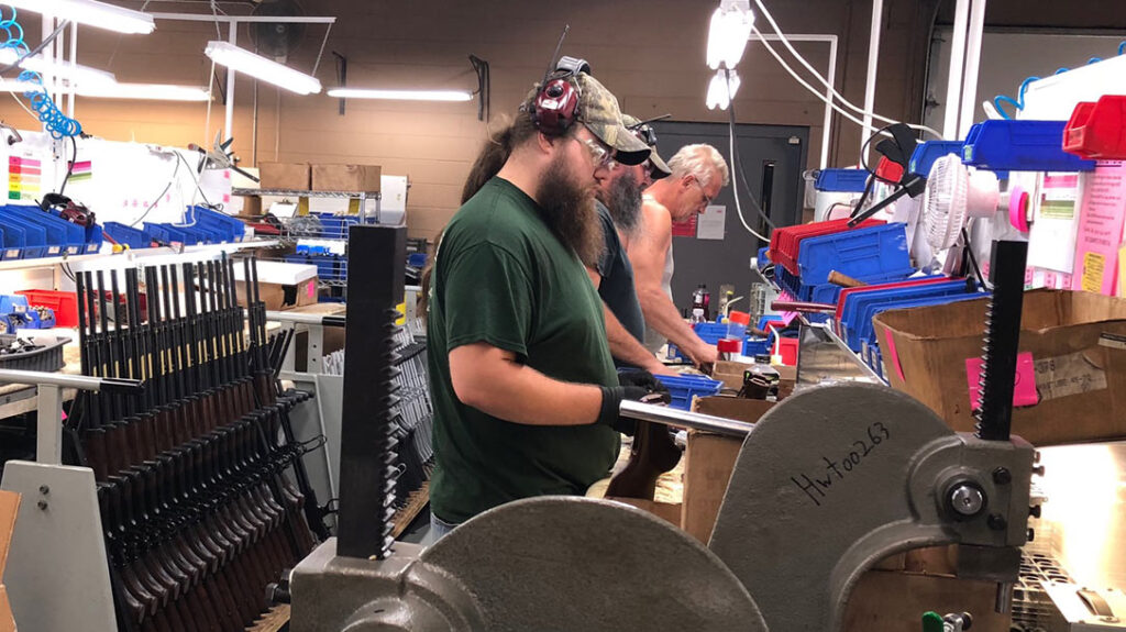 Employees work to assemble the rifles.